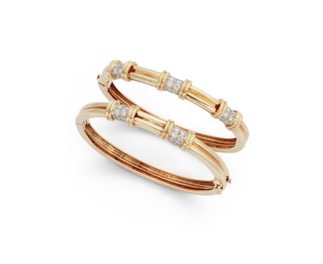 A pair of diamond-set bangles Each designed as a hinged reeded bangle, set to the front with either two or three brilliant-cu