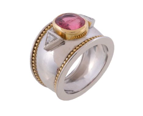 An 18 carat gold pink spinel and diamond ring by Theo Fennell, the oval cut pink spinel collet set between two triangular cut