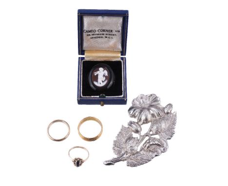 A late Victorian  cameo brooch, the oval cameo carved with a cherub playing a double aulos, within a jet surround, 2.3cm wide