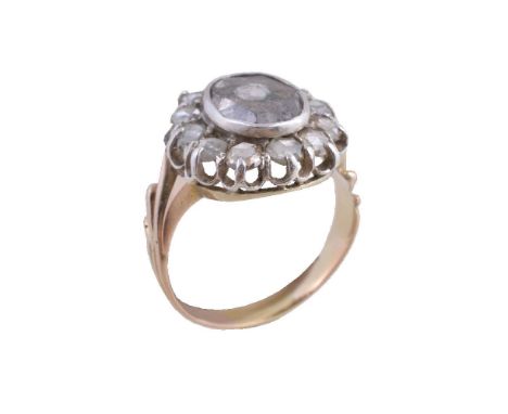 A rose cut diamond cluster ring, the central rose cut diamond collet set within a surround of further rose cut diamonds, fing
