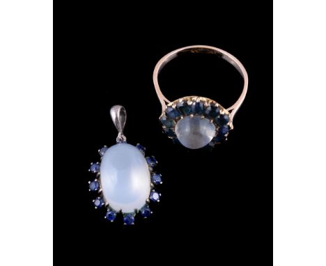 A moonstone and sapphire ring, the central circular cabochon moonstone within a surround of oval and circular cut sapphires, 