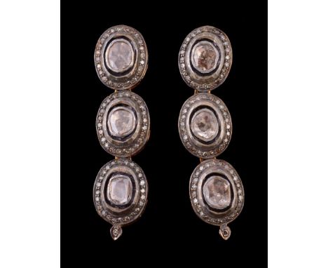 A pair of diamond earrings, the ear pendants set with lasque diamonds each within a surround of eight cut diamonds, with post