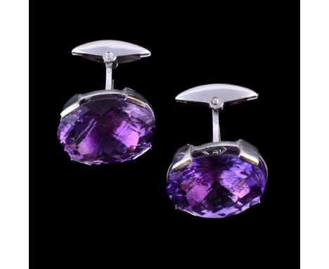A pair of 18 carat gold amethyst cufflinks, the oval vari cut amethysts within a four claw setting, London hallmark, with swi