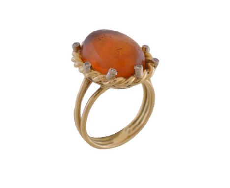 An amber and diamond dress ring, the oval cabochon amber within a ropetwist surround set with brilliant cut and eight cut dia