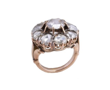 A diamond cluster ring, the central rose cut diamond claw set within a surround of further rose cut diamonds, finger size I