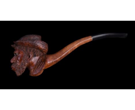 A briar pipe, early 20th century, carved as a man's head wearing a straw hat, with inset two-colour glass eyes, with a vulcan
