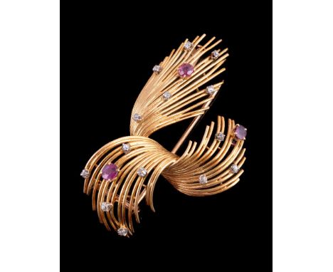 A 1970s 18 carat gold French gold coloured ruby and diamond brooch, of abstract form set with circular cut rubies and old cut