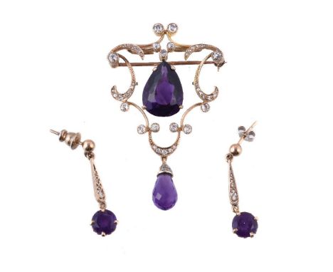 An amethyst and diamond brooch/pendant, the pear cut amethyst within an openwork scrolling surround set with old cut diamonds