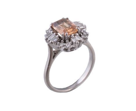 A 1970s topaz and diamond ring, the rectangular cut golden topaz claw set within a surround of baguette cut and brilliant cut