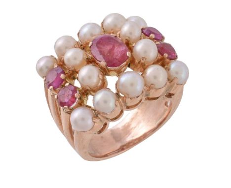 A cultured pearl and ruby dress ring, the central oval cut ruby within a surround of cultured pearls and circular cut rubies,