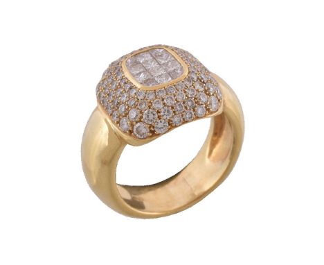 A diamond ring, the central panel set with princess cut diamonds within a surround of pavé set brilliant cut diamonds, approx