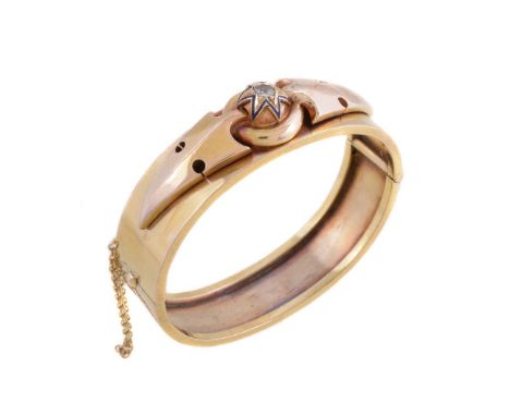 A late Victorian diamond hinged bangle, the old cut diamond, estimated to weigh 0.20 carats, within a blue enamel star surrou