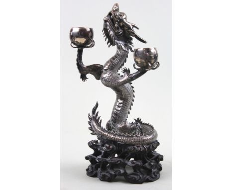 Exquisitely detailed 19th century Chinese white metal Dragon candlestick mounted on a very intricately carved wooden stand 