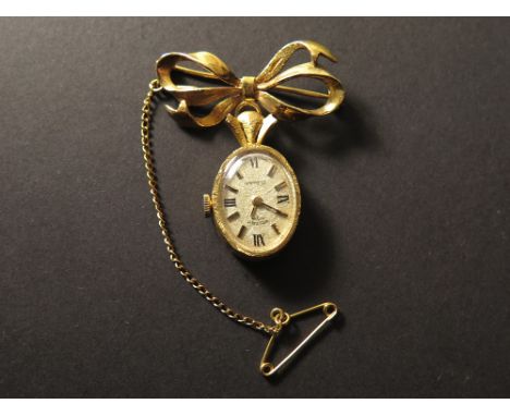 A 9ct hallmarked ladies Rotary fob watch with an oval dial suspended from brooch modelled as a bow. Total weight approx 10.5g