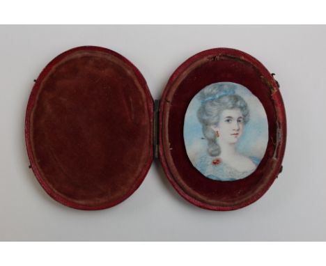 Early victorian portrait miniature on ivory of a young lady dressed in blue. Loosely presented in an ovak morrocco leather ca