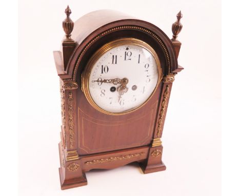 Edwardian period mantle clock with brass decoration and an enamel dial. Two train movement striking on a gong.