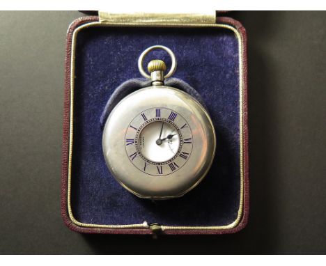 In its original box. Silver half hunter pocket watch by J.W Benson, hallmarked London 1935. The outer case with a black ename