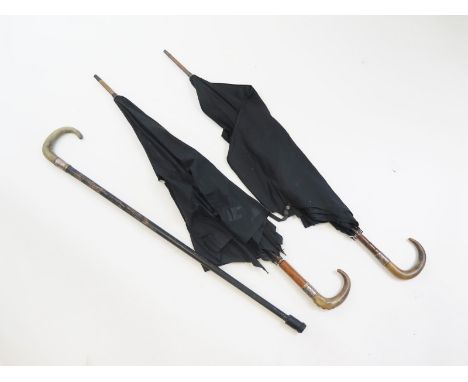 Two Victorian black horn handled umbrellas with silver collars and a further converted to a walking stick.