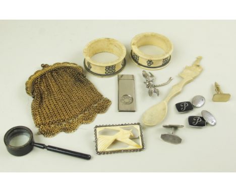 Mixed lot including a gilt sovereign purse, two bone napkin rings and a spoon, a miniature cast iron magnifying glass, two pa