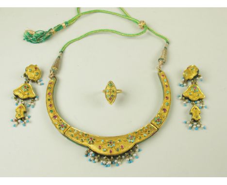 In its fitted case of issue a Yellow metal suite of Indian Wedding Jewellery consisting of Ring, Ornate necklace and Earrings