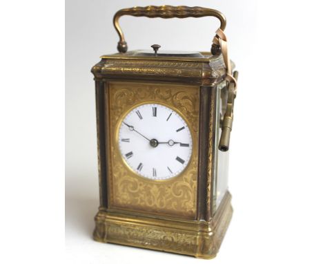 French gilt brass carriage clock with repeater, black Roman numerals on a white enamel face, with a floral engraved brass sur