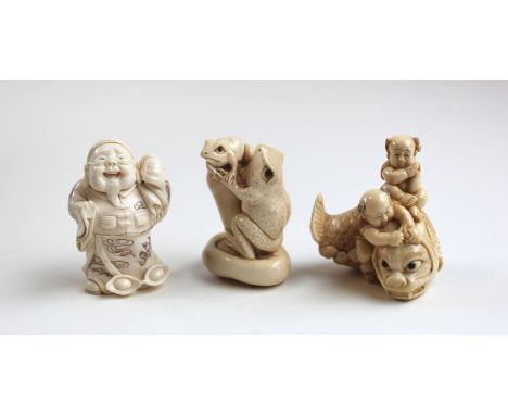 Three beautifully carved 19th century Japanese Netsuke depicting a carp, frogs and a figure carrying a sack. All signed. 