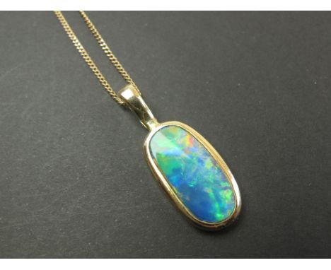 Opal pendant mounted within a 14ct Gold casing and hung on a fine gold chain