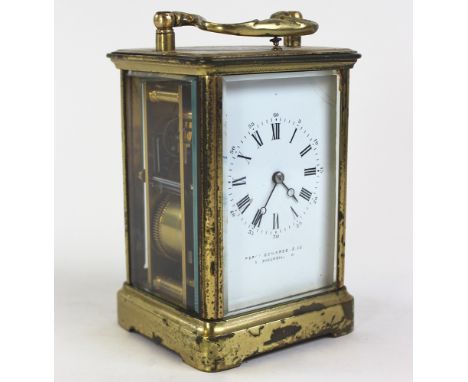 Brass cased carriage clock with swing handle, five bevelled glass panels, the movement marked "Brevete Paris", the white enam