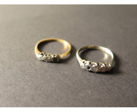 Two Platinum & 18ct gold diamond set rings, each with a row of small diamonds but one missing on each ring