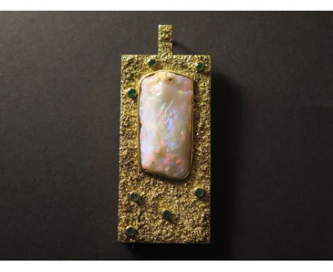 585 marked Pendant with large Opal stone surrounded by emeralds. Vendor states Greek manufacture weight 34 grams 