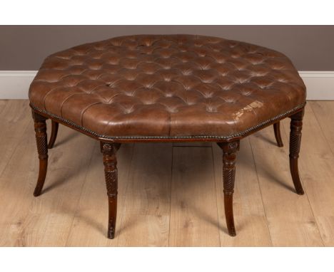 The stool with a leather upholstered button top and raised on out-splayed legs.102cm wide x 50cm highQty: 1Some staining to t