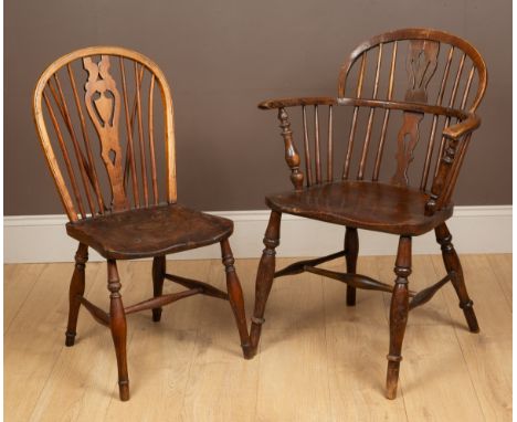 One with a low back and elm seat on turned legs united by an H-stretcher, together with a hoop-back chair with an elm seat on