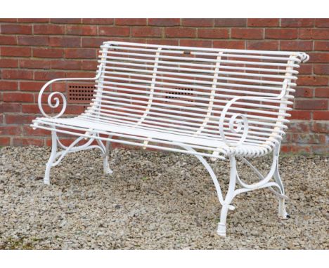 The bench with a slatted back and seat, scrolling arms and a cast seat. With a brass label for ' Usine S. Sauveur Arras'.150c