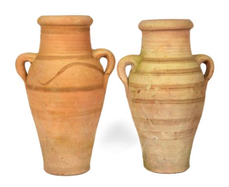 Of amphora form with incised decoration and twin handles.43cm highQty: 2In generally good condition. With light weathering th