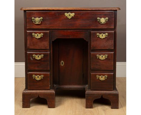 With a caddy top. The top drawer opening on hinges and sliding out to reveal a fitted interior and writing surface above an a