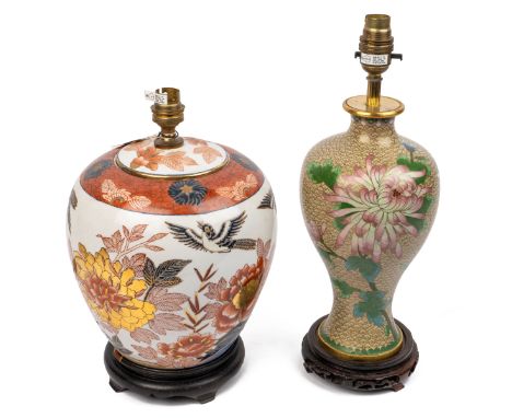The first a baluster shaped cloisonné lamp on a wooden stand. The second an Imari patterned lamp.The cloisonné lamp 39cm high