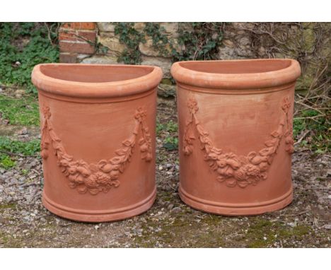 Each planter of D-section with a flowerhead and fruiting swag ornament.57cm wide x 33cm deep x 61cm highQty: 2In good conditi