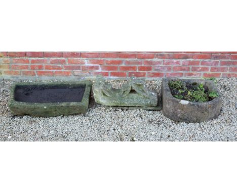 The troughs of rough cut form and the element previously a part of a traceried window.  The element 64cm high. The trough wit