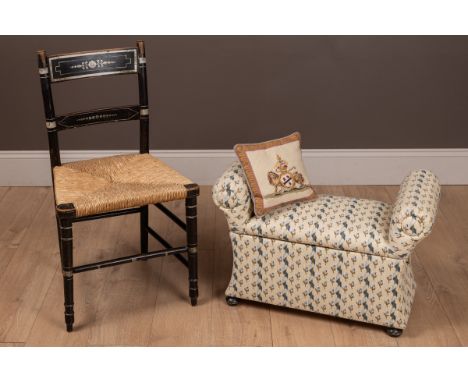 The ottoman with scrolling bolster arms on bun feet, and a 19th Century rush-seated ebonised chair with white painted decorat