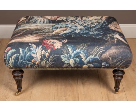 The top is upholstered in a verdure tapestry style patterned material, standing on tapering fluted legs and terminating in br