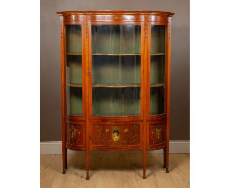 The cabinet with painted decoration of flowers, husk swags and portrait vignettes, a single door enclosing conforming shelves