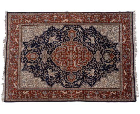 With a blue ground decorated with hunting scenes and a central medallion, the guarded border with further scenes of deer hunt