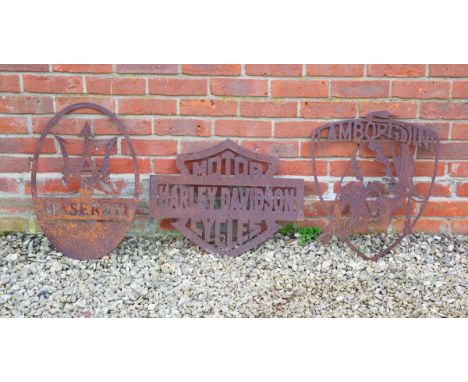 A pressed-steel Harley-Davidson Motorcycles sign, a Lamborghini sign, and a Maserati sign.The Harley-Davidson sign 57.5cm wid