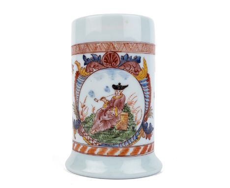 The South German tankard decorated in enamels with a vignette of an oriental gentleman smoking a pipe, set within a decorativ