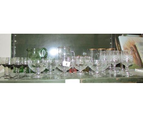A shelf of assorted drinking glasses