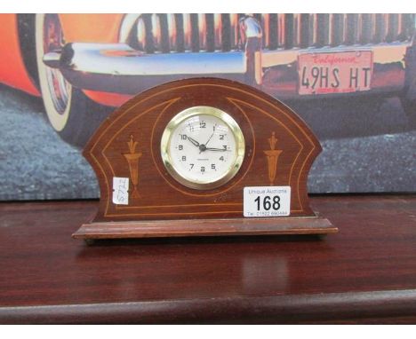 A small mahogany inlaid mantel clock