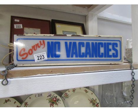 A vintage illuminated 'Sorry No Vacancies' hotel B & B sign