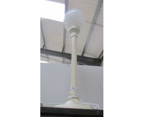 A tall table lamp with globe shade