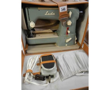 A cased vintage LADA sewing machine
