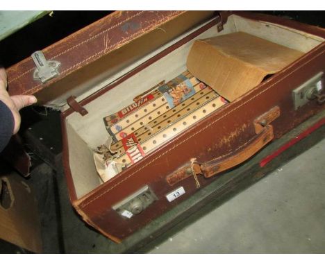 A vintage suitcase containing vintage wooden toys